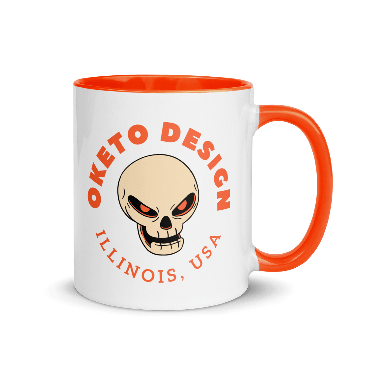 A white ceramic mug with a bright orange handle and interior, featuring a skull graphic and the text 'OKETO DESIGN' and 'ILLINOIS, USA' in orange on the front