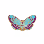 A blue butterfly enamel pin with purple and gold details on a plain white background
