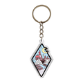 A diamond-shaped acrylic keychain featuring an illustrated castle scene with a crescent moon, stars, and a winding river, attached to a silver metal key ring and chain on a plain white background