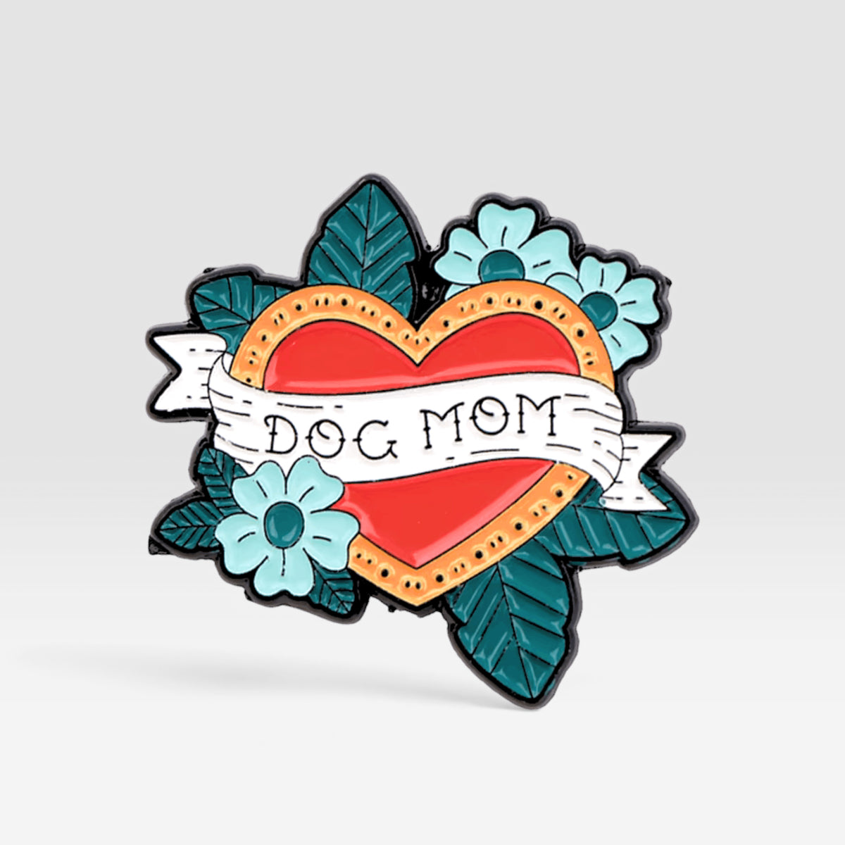 Heart-shaped enamel pin featuring a dog mom tattoo-inspired design with flowers and a red heart