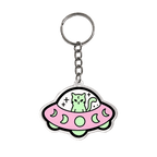 A cute acrylic keychain featuring a cartoon green cat sitting inside a pink UFO with moon patterns, attached to a silver metal key ring on a plain white background