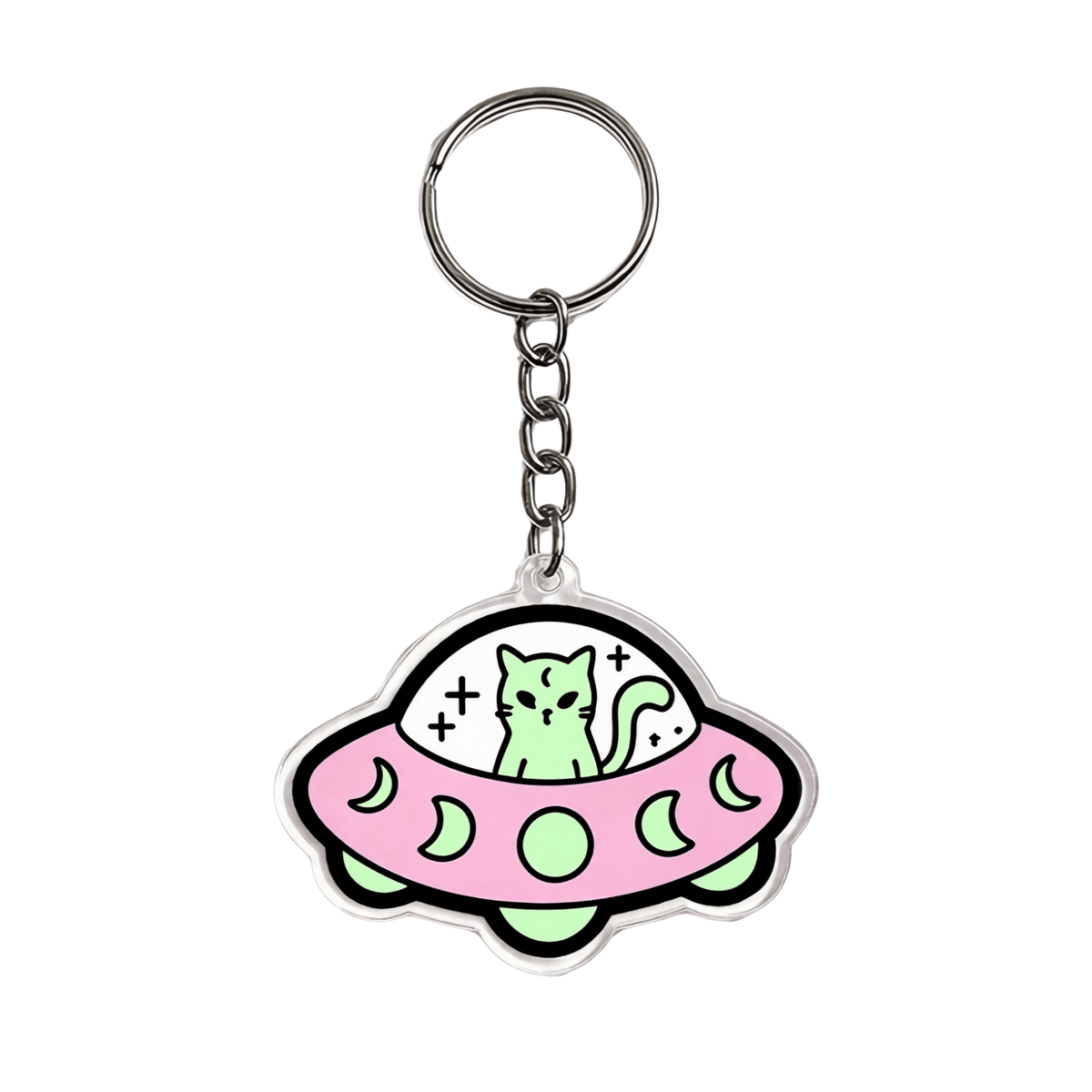 A cute acrylic keychain featuring a cartoon green cat sitting inside a pink UFO with moon patterns, attached to a silver metal key ring on a plain white background