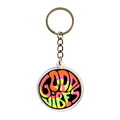 An acrylic keychain featuring a round groovy pattern with the words 'GOOD VIBES' attached to a silver metal key ring on a plain white background