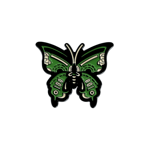 A green and black butterfly enamel pin with white decorative details, centered on a solid white background
