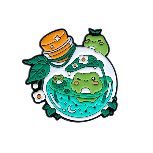 A nature-themed enamel pin with frogs swimming inside a potion bottle on a white background