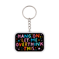 A rectangle acrylic keychain featuring colorful lettering that says 'HANG ON LET ME OVERTHINK THIS...' on a black background with a silver metal key ring and chain